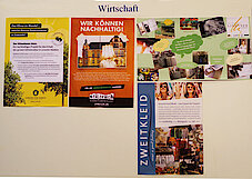 Plakatwand zum Thema Wirtschaft. Oben links: Plakat der Baumschule Lorenz von Ehren und von Stilbruch (Foto Gisela Baudy)