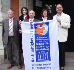 Rolf Buhs, Gisela Baudy, Torsten Meinberg, Heidi Consentius und Frank Wiesner präsentieren die UNESCO-Fahne vor dem Harburger Rathaus (Foto Elke Reich)